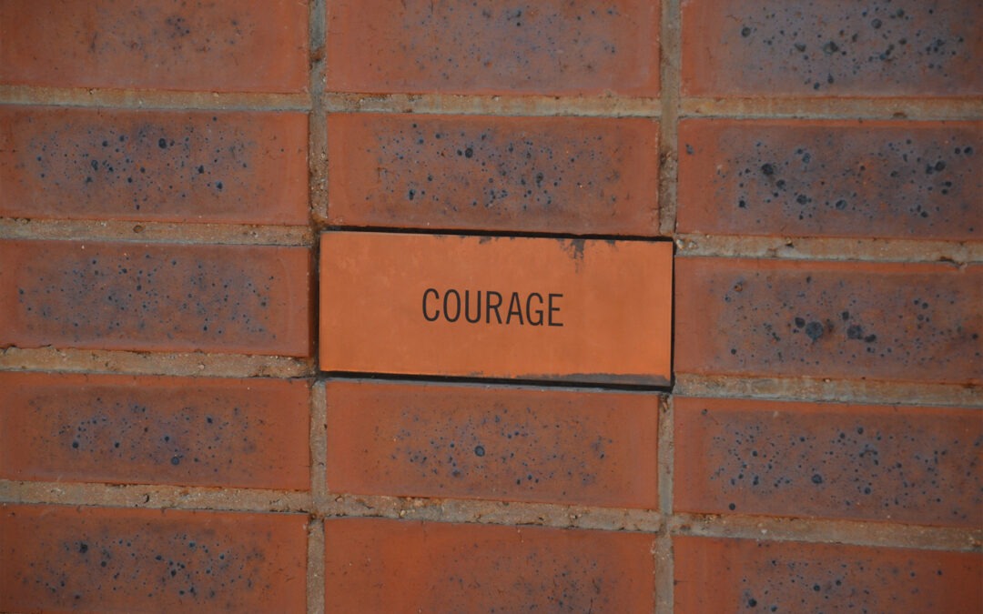 red bricks that say courage