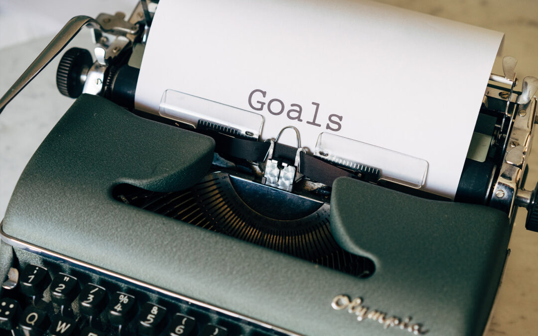typewriter with a sheet of paper that says Goals
