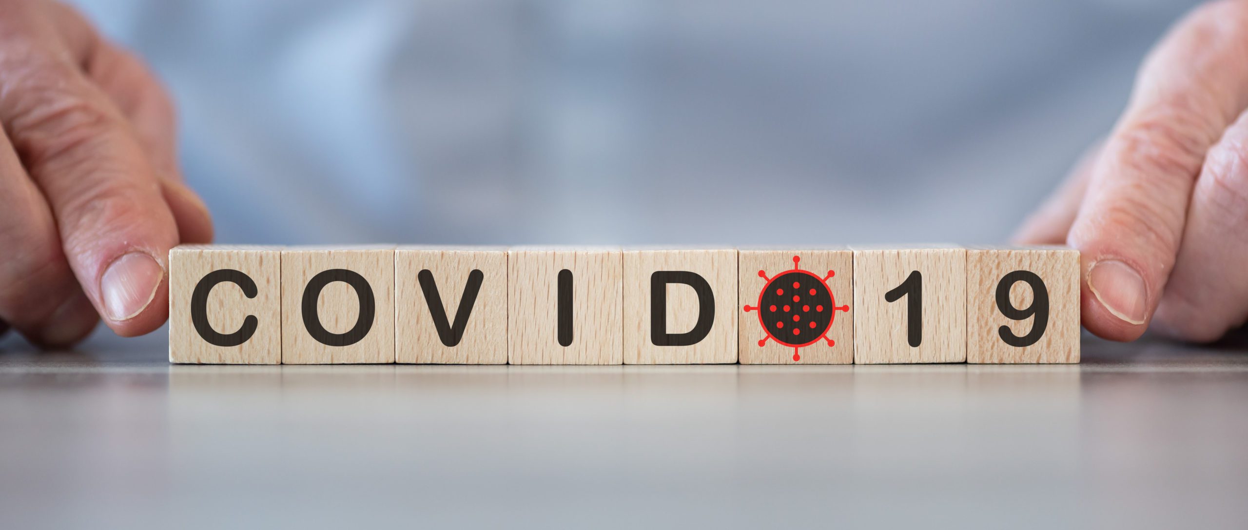Scrabble board pieces that spell out COVID-19
