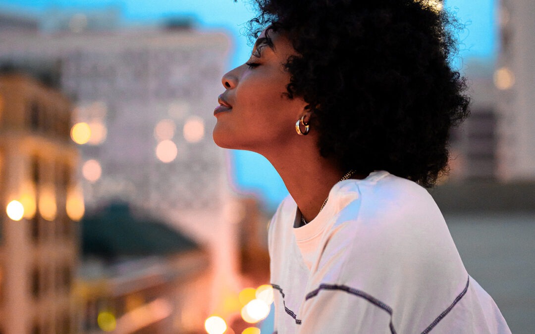 black women smiling rooftop city modest taking risks