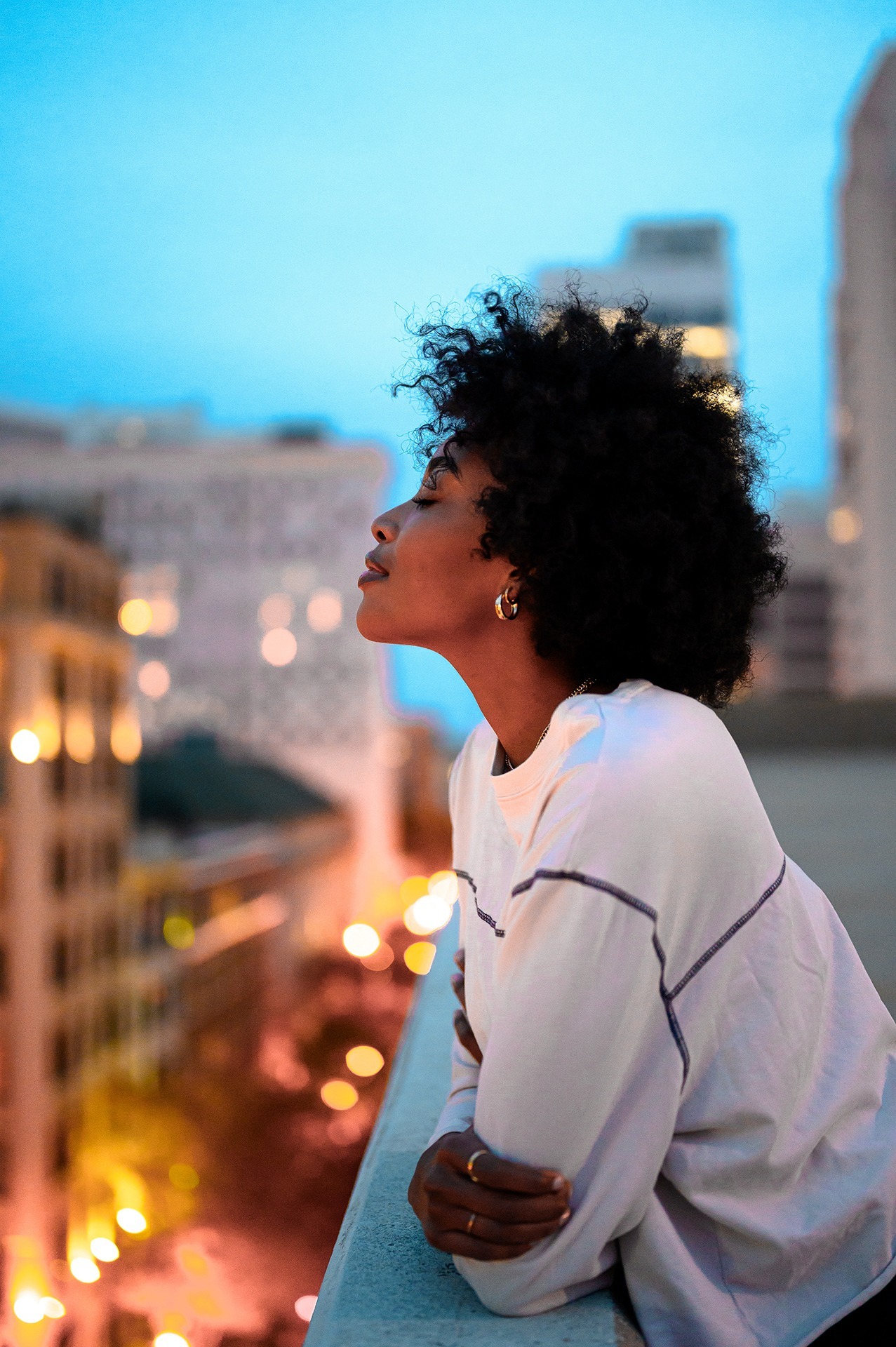 black women smiling rooftop city modest taking risks
